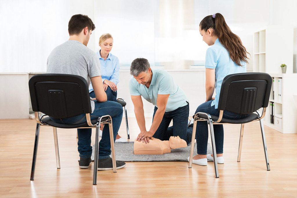 instructor teaching first aid cpr technique