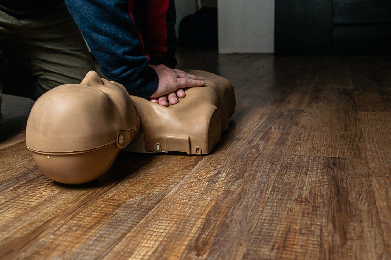 man implementing CPR on a dummy